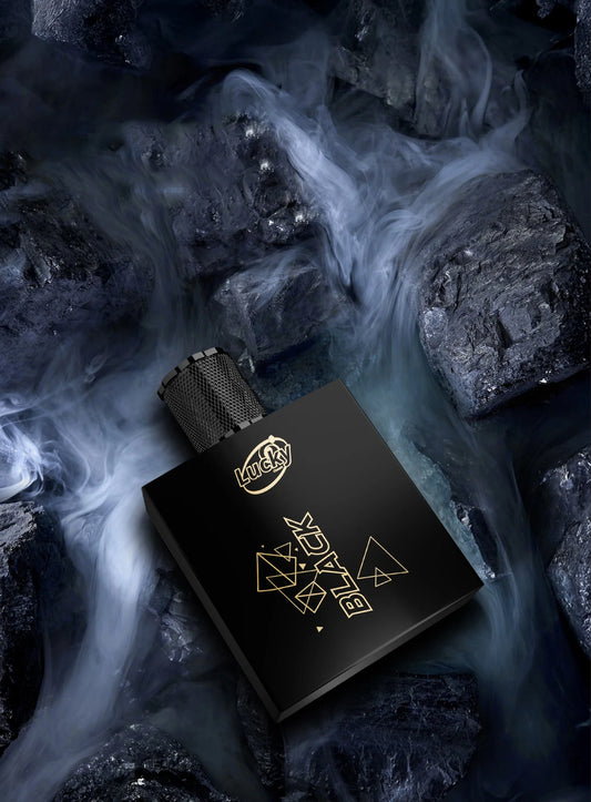 Lucky Black perfume bottle on dark charcoal rocks – bold and intense men's fragrance banner